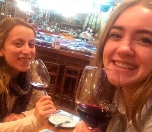 Two girls drinking wine