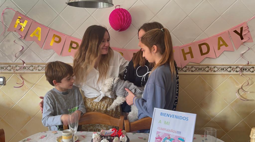 English girl and Spanish kids celebrating a birthday party